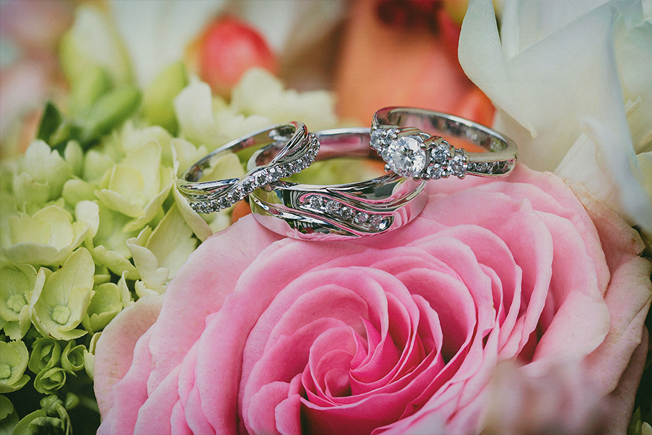 Wedding rings sitting on flowers.