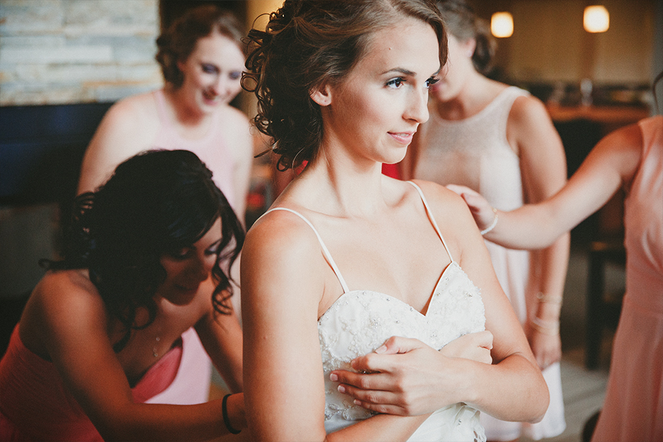 A bride gets help with her dress.