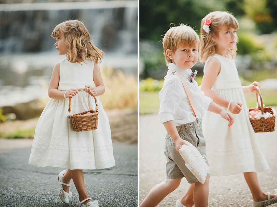 Flower girl and ring bearer in cream dress and grey shorts with suspenders.