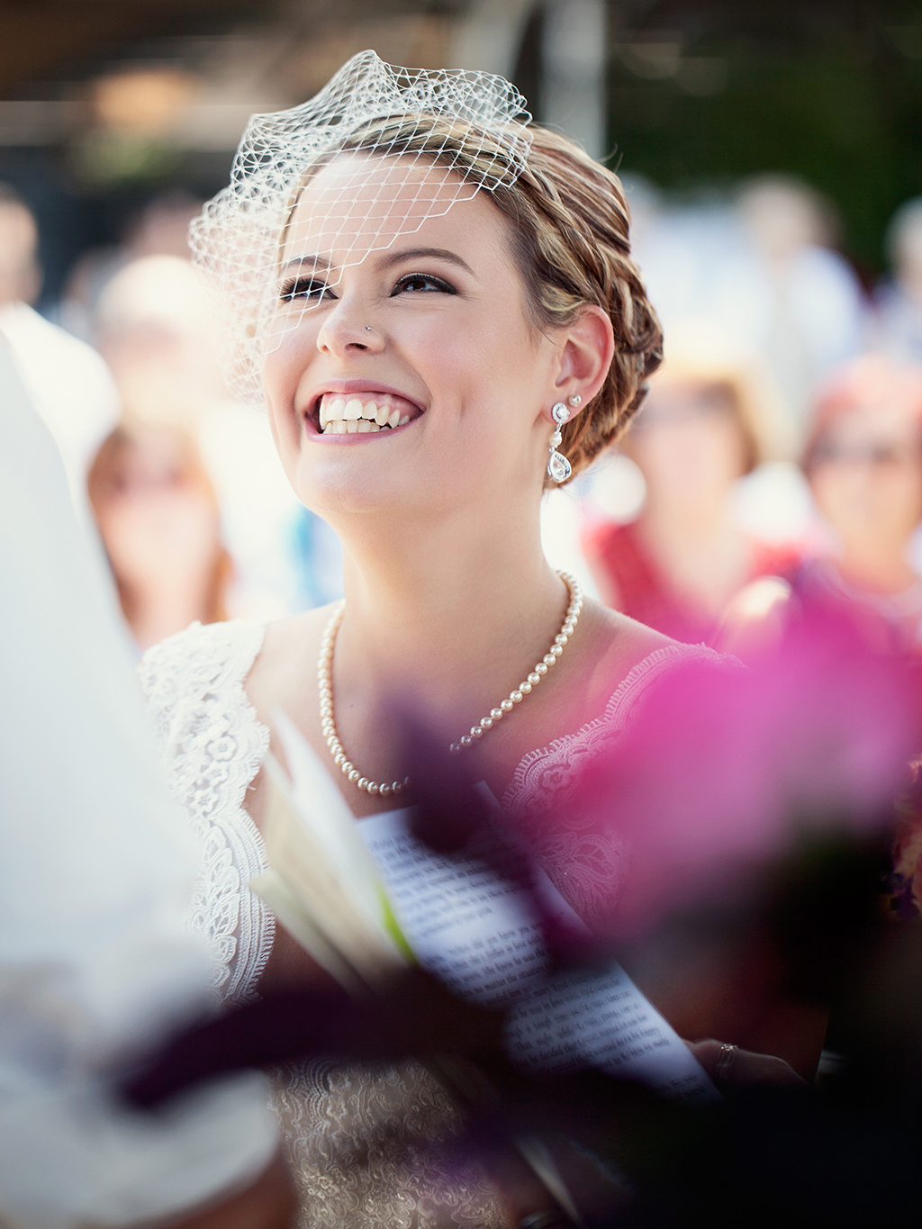 A bride grins as her groom recites his vows during a wedding ceremony in Kelowna.