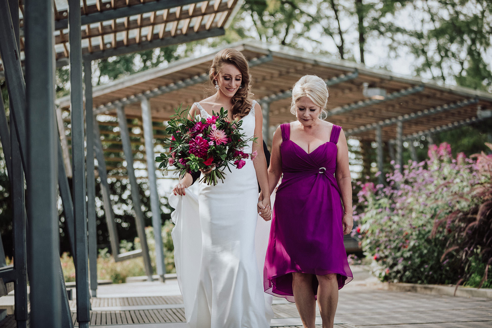 Mother walks aisle with bride daughter