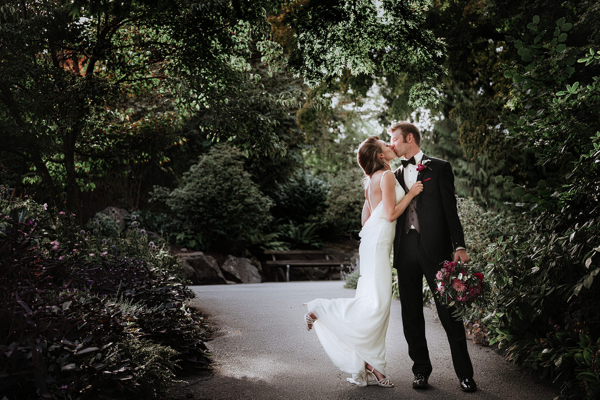 romantic kiss on a garden path